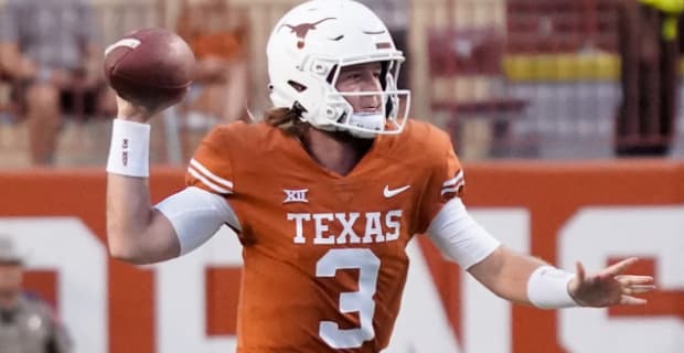 Texas Longhorns quarterback Quinn Ewers attempts a pass during a college football game.